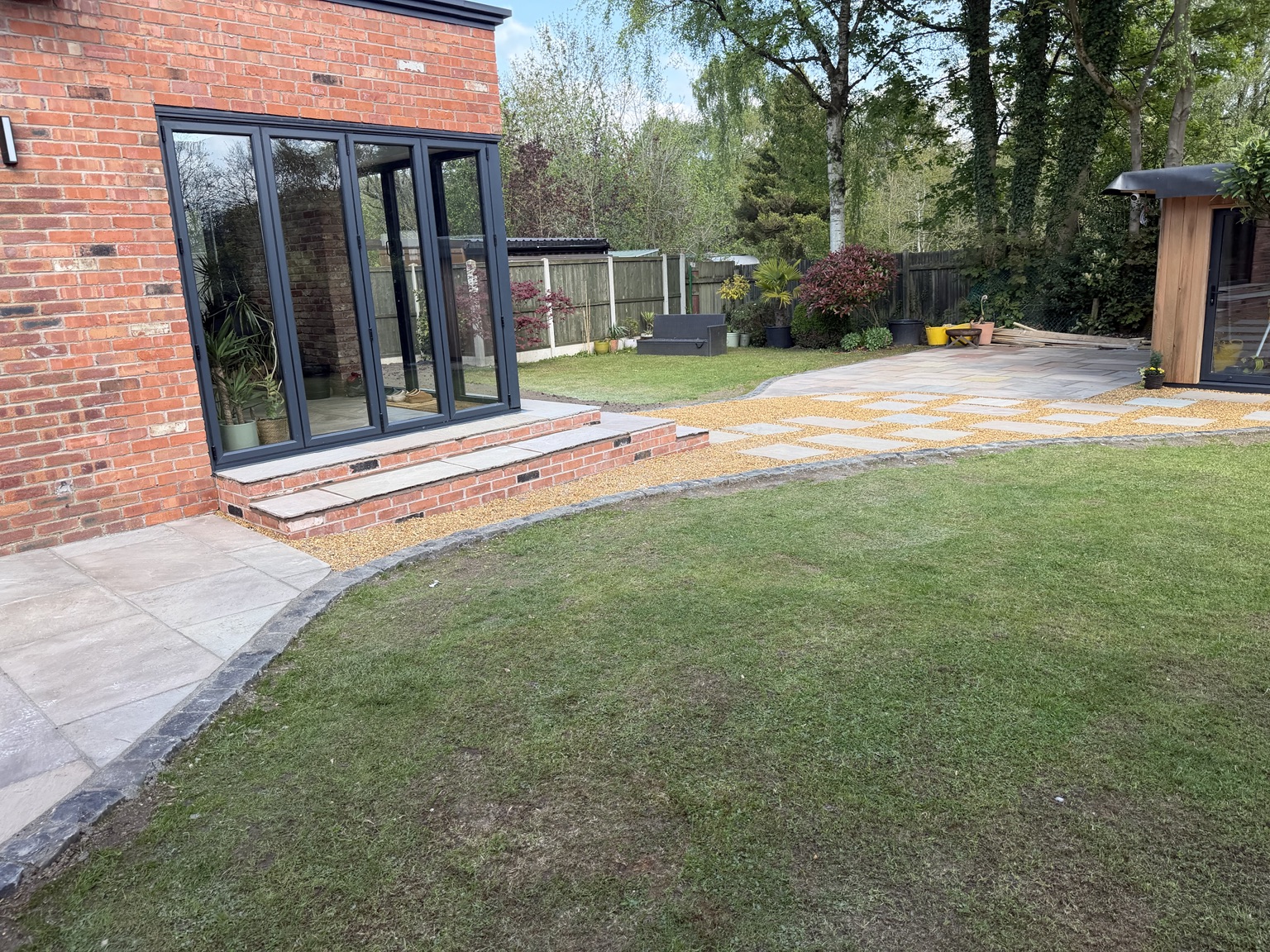 The rear extension, paved patio and landscaping by Coppice